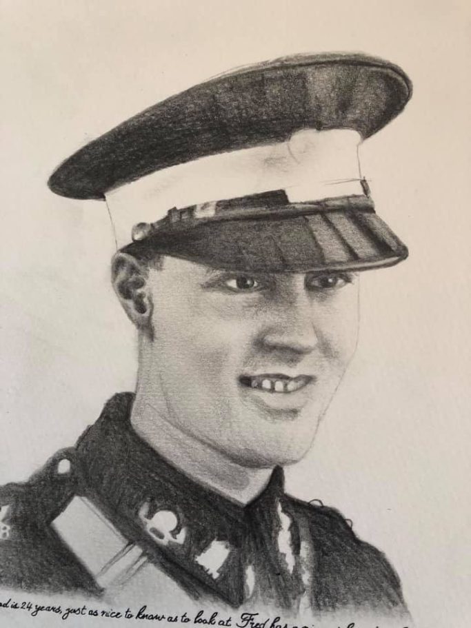 Black and white portrait of a smiling young soldier in uniform with a cap.